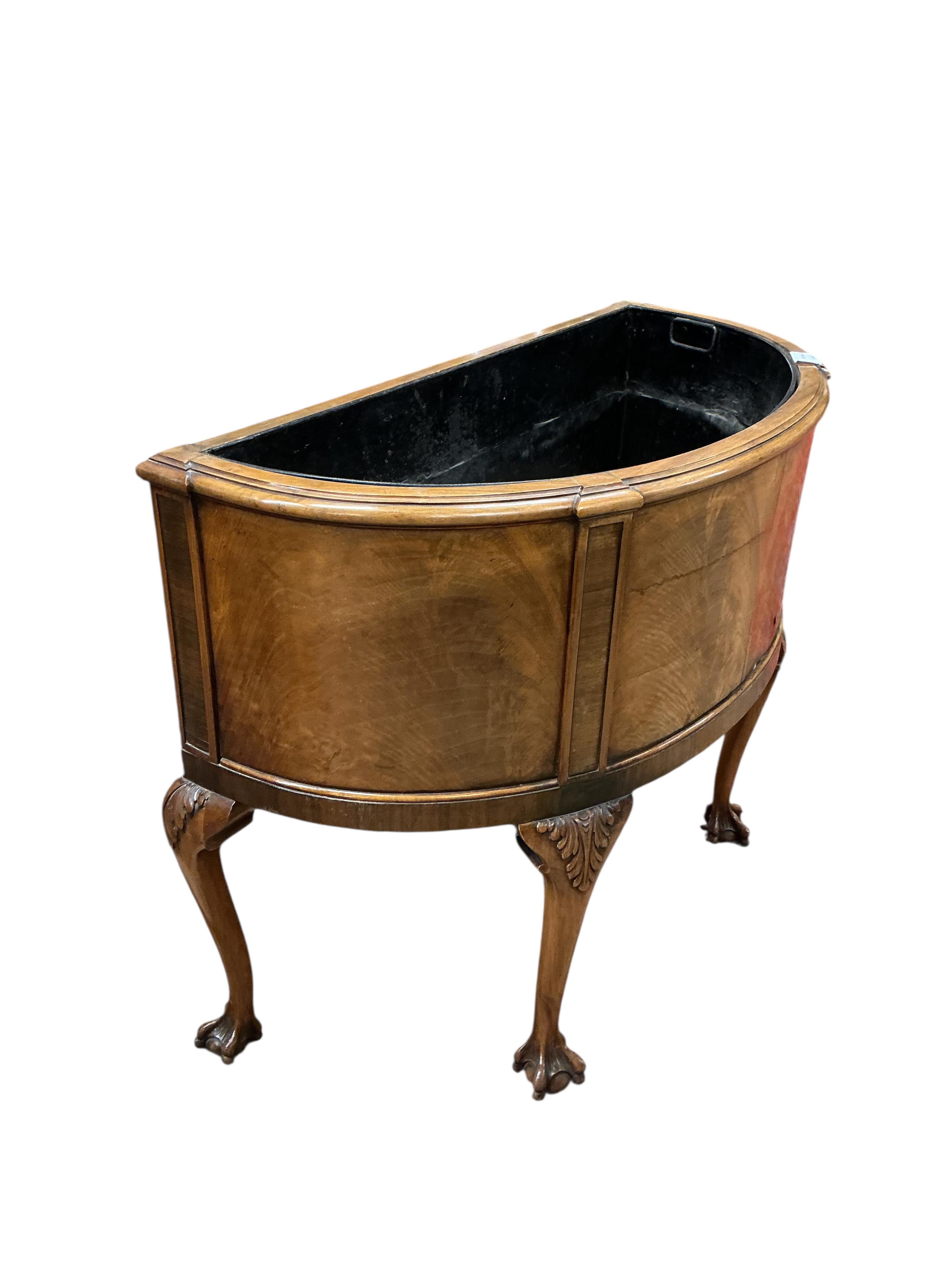 A Queen Anne Revival walnut bowfront jardiniere, width 86cm, depth 40cm, height 69cm